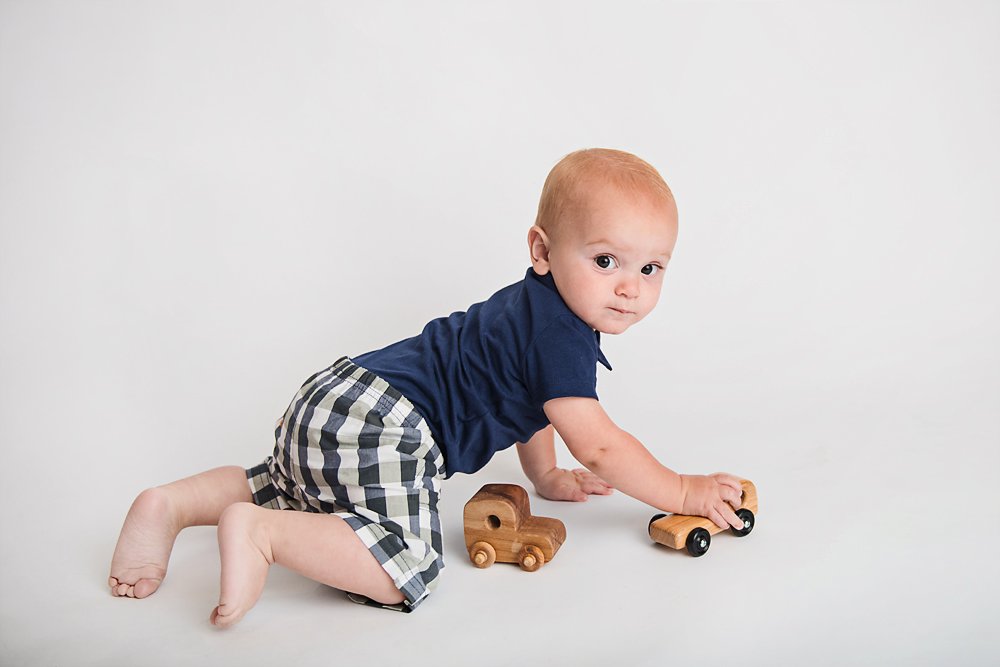 1yr old boy playing with wooden cars